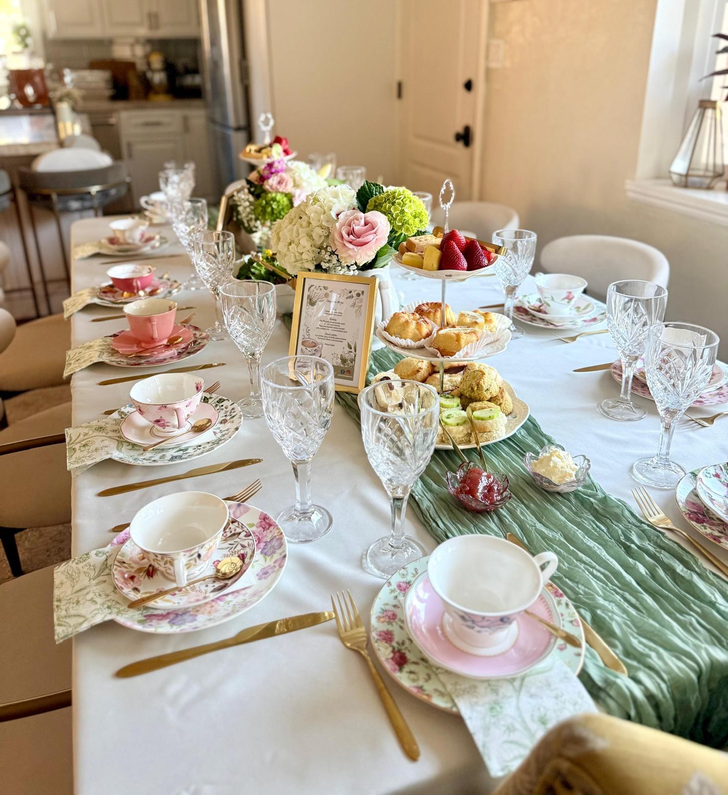 Elegant tea party table with floral china and green runner