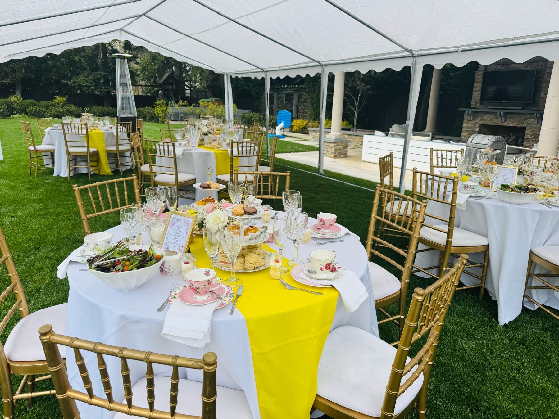 Outdoor tea party under a white tent
