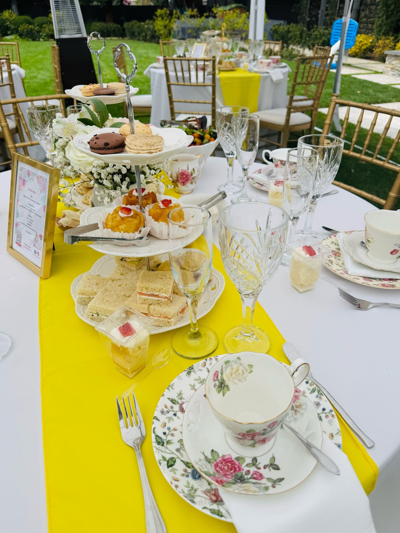 Tea table with yellow runner and tiered stand