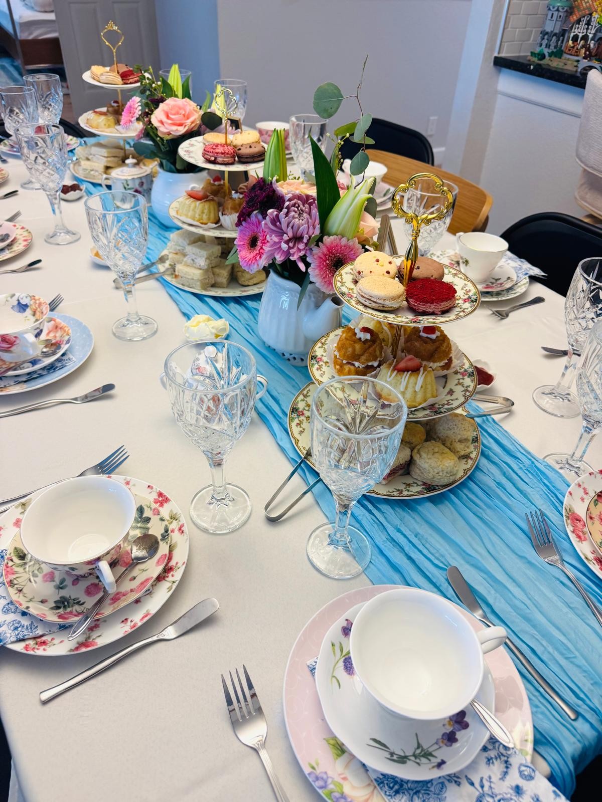 Tea table with blue runner and floral china
